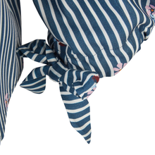 Load image into Gallery viewer, Close-up of a blue and white striped fabric accessory tied in a knot, with small pink and red floral accents, on a white background.
