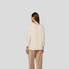 Load image into Gallery viewer, Woman wearing a beige sweater and pants on a light gray background
