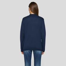 Load image into Gallery viewer, Person wearing a navy blue sweater and jeans on a light gray background
