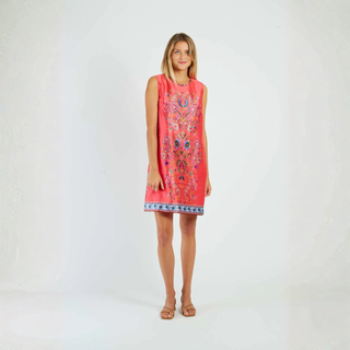 Woman wearing a red dress with floral patterns on a white background