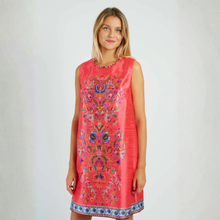 Load image into Gallery viewer, Woman wearing a coral dress with colorful floral embroidery on a plain background
