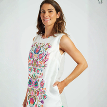 Load image into Gallery viewer, Woman wearing a white sleeveless dress with colorful floral patterns on a white background
