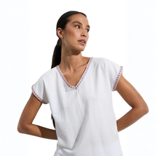 Load image into Gallery viewer, Woman wearing a white top with red trim on a white background
