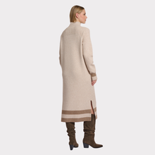 Load image into Gallery viewer, Woman wearing a long beige coat with a white background
