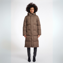 Load image into Gallery viewer, Person wearing a long brown puffer coat on a white background
