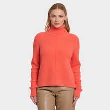 Load image into Gallery viewer, Woman wearing a coral turtleneck sweater on a white background

