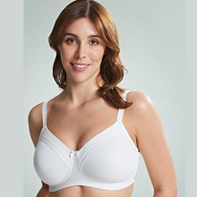 Load image into Gallery viewer,  A close up of a model wearing the Royce Maisie Wirefree Smooth Cup Bra in Ivory. 

