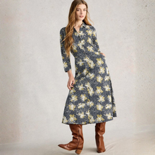 Load image into Gallery viewer, Woman wearing a floral dress with long sleeves and brown boots on a plain background
