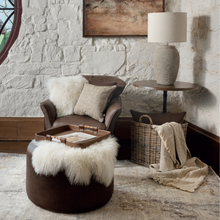 Load image into Gallery viewer, A promo shot of the Quilo Duo Cream Cushion in a room on a brown chair
