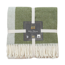 Load image into Gallery viewer, Scatterbox Riley throw with tones of cream, grey and green, wrapped with a ribbon and a Scatterbox label on top, finished with cream fringing
