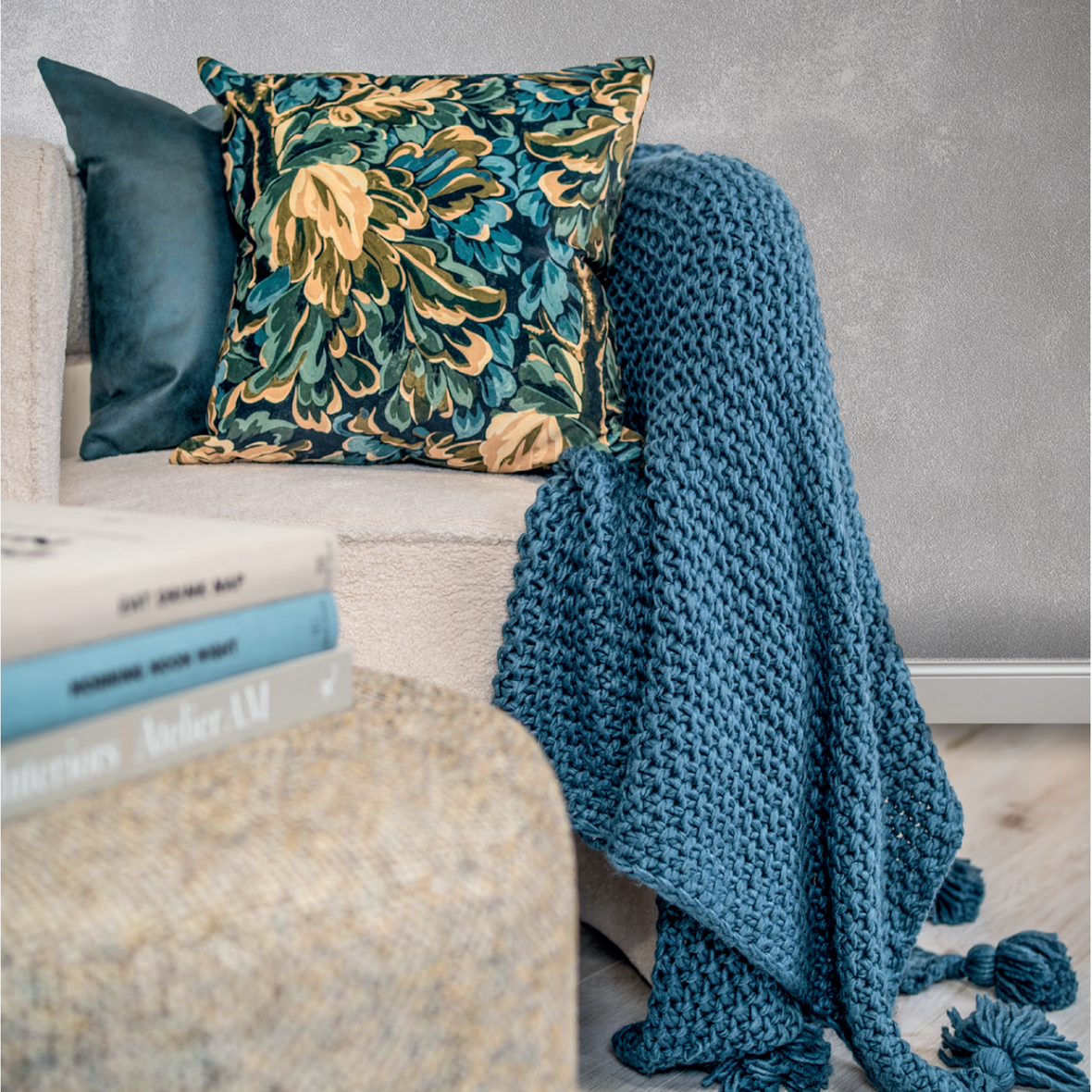 The Scatterbox Leaf Green Cushion on a chair with the Collins blue throw draped over beside it
