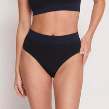 Load image into Gallery viewer, A model facing forwards wearing the Sloggi Ever Infused Aloe High Waist Brief in Black.
