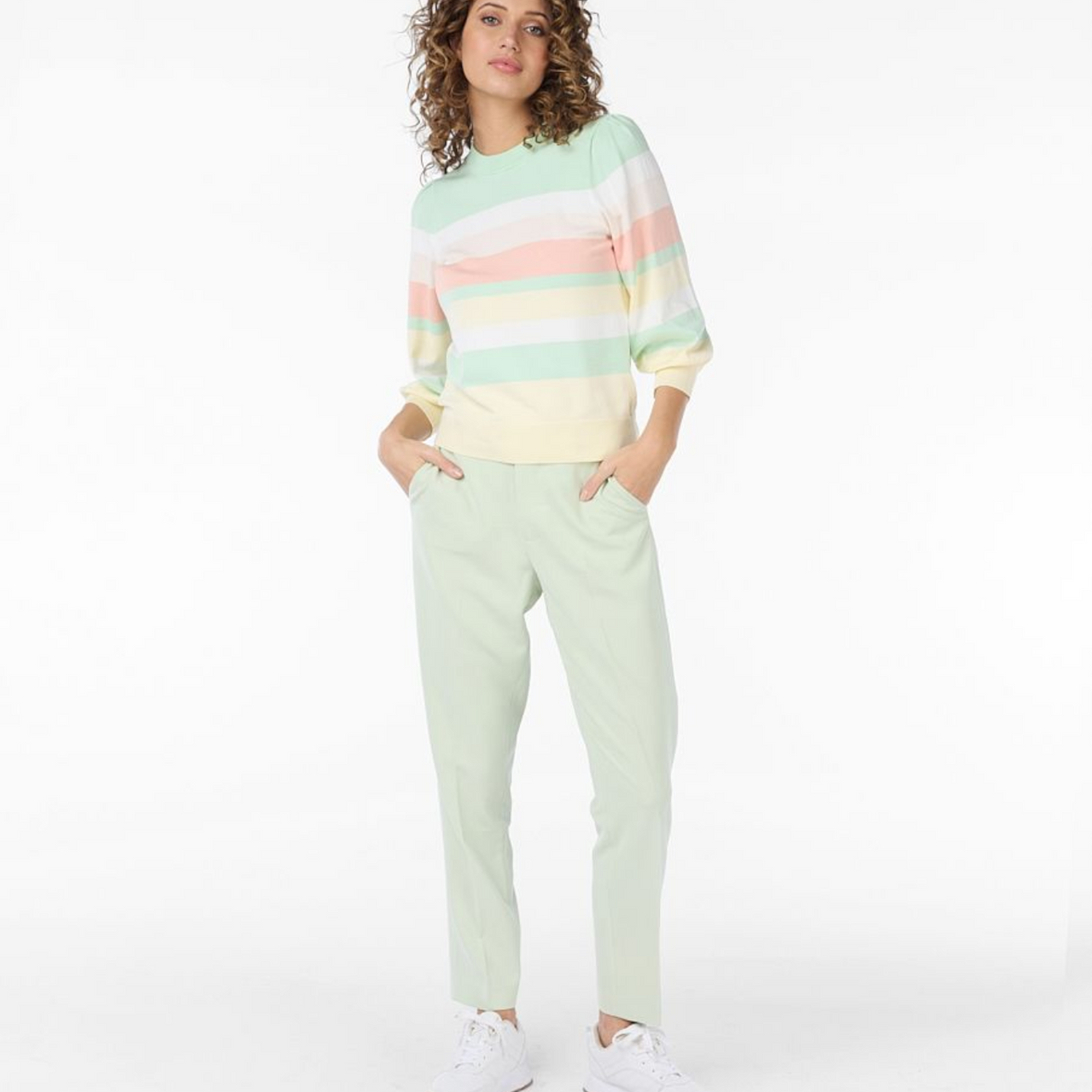 female  model wearing esqualo striped sweater in pistachio colour with hands in pockets