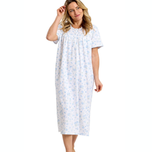 Load image into Gallery viewer, Woman wearing a white nightgown with blue floral pattern on a white background
