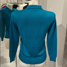 Load image into Gallery viewer, A teal blue knit polo sweater displayed on a white mannequin torso, showing the back view. The sweater has a ribbed collar, long sleeves, and a ribbed hem.
