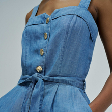 Load image into Gallery viewer, Blue denim dress with gold buttons on a neutral background
