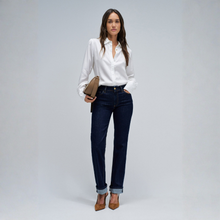 Load image into Gallery viewer, Lady in jeans and a white shirt on grey background 
