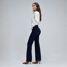 Load image into Gallery viewer, Woman wearing dark blue jeans and a white shirt on a gray background
