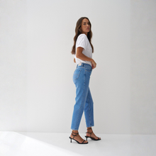 Load image into Gallery viewer, Woman wearing blue jeans and a white shirt on a white background
