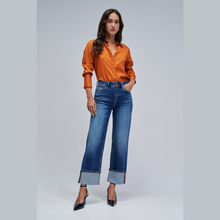Load image into Gallery viewer, Lady in jeans with orange shirt and heels 
