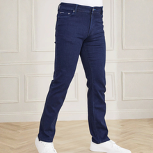 Load image into Gallery viewer, Blue jeans worn by a person on a white background
