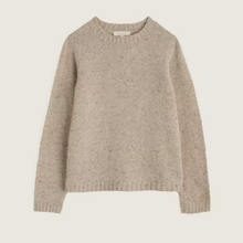 Load image into Gallery viewer, A light beige knit sweater with subtle dark flecks, featuring a crew neck and ribbed cuffs and hem, shown against a solid off-white background.
