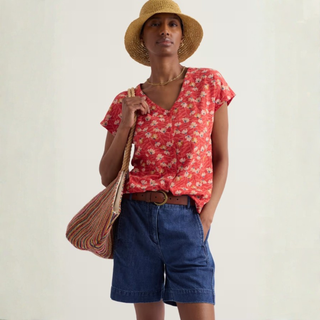 Woman in top with Shorts, bag and Hat 