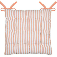 Load image into Gallery viewer, A square, tufted cushion with vertical peach and white stripes, featuring two peach ribbon ties at the top corners, shown against a plain white background.
