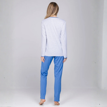 Load image into Gallery viewer, A woman stands with her back to the camera wearing a light heather gray long-sleeve top and bright blue pants against a plain light gray studio background.
