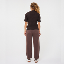 Load image into Gallery viewer, A woman is shown from the back wearing a dark brown short-sleeve knit top and matching wide-leg brown trousers, paired with white sneakers, against a plain white studio background.
