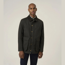 Load image into Gallery viewer, A man wearing a dark olive green utility jacket with gold-tone buttons, a patterned shirt, and dark trousers, standing against a plain light gray studio background.
