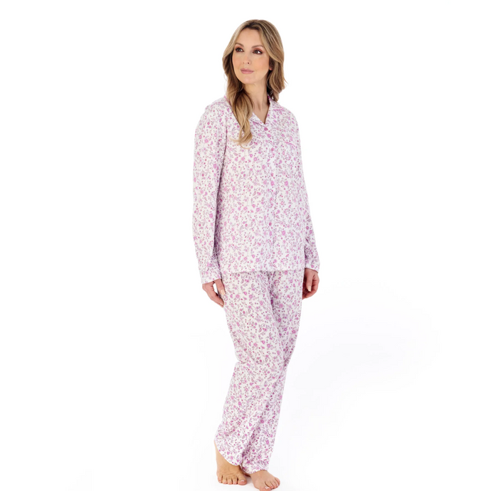 A model wearing the Slenderella Ditsy Floral Jersey Tailored Pyjama Set in Pink. 