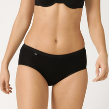 Load image into Gallery viewer, A close up of a model wearing the sloggi midi brief in black. 
