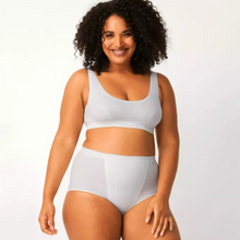 Load image into Gallery viewer, A model smiling while wearing the Sloggi Maxi Control Brief. 

