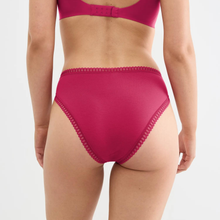Load image into Gallery viewer, Rear view of a model wearing high-waisted magenta pink underwear with scalloped lace trim, paired with a matching bra top against a light gray background.
