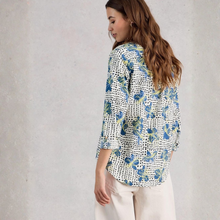 Load image into Gallery viewer, Woman wearing a floral patterned blouse against a plain background
