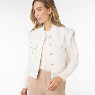 female model wearing short tweed gilet in offwhite colour smiling