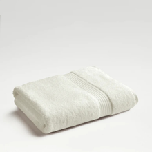 Load image into Gallery viewer, Folded almond towel on a light gray background
