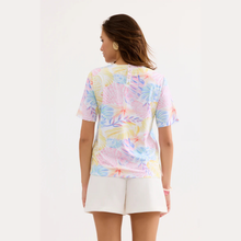 Load image into Gallery viewer, Woman wearing a colorful floral-patterned shirt on a white background
