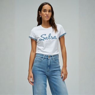 Woman wearing a white t-shirt with 'Salsa Jeans' text and blue jeans on a gray background
