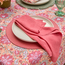 Load image into Gallery viewer, Table setting with a pink napkin on a floral tablecloth
