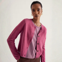 Load image into Gallery viewer, A woman wearing a pink knit cardigan over a mauve top and brown pants, photographed against a plain light background.
