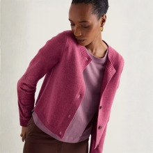Load image into Gallery viewer, A woman wearing a pink knit cardigan over a mauve top and brown pants, photographed against a plain light background.
