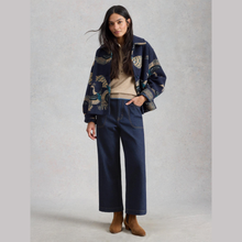 Load image into Gallery viewer, Model posing, Wearing White Stuff Tia Dark Denim in dark denim, with a light grey background.
