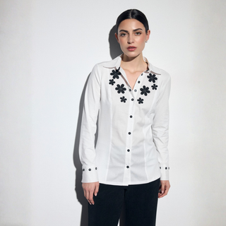 Model in white shirt with black flowers on a white background 