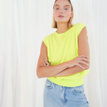 Load image into Gallery viewer, Person wearing a bright yellow sleeveless top and blue jeans against a white background
