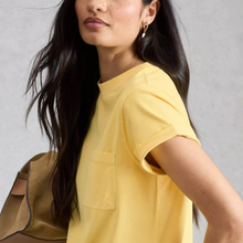 Load image into Gallery viewer, Woman wearing a yellow t-shirt against a gray background
