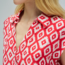 Load image into Gallery viewer, Red and white patterned shirt worn by a person with blonde hair.
