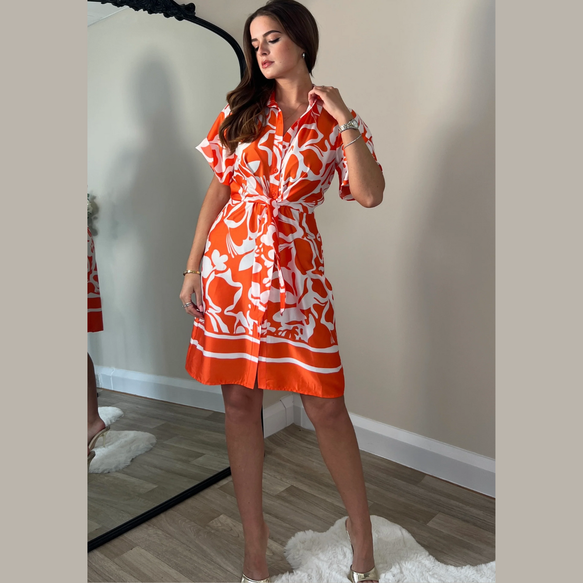 female model wearing girl in mind verity shirt dress in orange colour looking away from camera