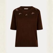 Load image into Gallery viewer, A dark brown short-sleeve knit sweater with decorative bee embellishments on the chest and shoulders, displayed against a light cream background.
